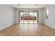 Bright and airy living room showcasing wood-style flooring and sliding glass doors to the backyard at 5359 W Las Palmaritas Dr, Glendale, AZ 85302
