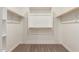 Well-organized walk-in closet with multiple shelves, maximizing storage space at 5359 W Las Palmaritas Dr, Glendale, AZ 85302