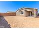 Large, dirt backyard featuring a block fence and covered patio ready for landscaping at 5401 W Las Palmaritas Dr, Glendale, AZ 85302