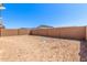 Large, empty backyard featuring a block fence in need of landscaping at 5401 W Las Palmaritas Dr, Glendale, AZ 85302