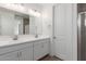 This bright bathroom boasts a double sink vanity with modern fixtures and bright lighting at 5401 W Las Palmaritas Dr, Glendale, AZ 85302