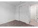 This carpeted bedroom features a closet and a neutral color scheme at 5401 W Las Palmaritas Dr, Glendale, AZ 85302