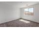 Bedroom with carpet flooring and a large window providing natural light at 5401 W Las Palmaritas Dr, Glendale, AZ 85302