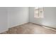 This bedroom features wood flooring and a bright window at 5401 W Las Palmaritas Dr, Glendale, AZ 85302