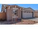This single-Gathering home has a two-car garage, brick driveway, neutral exterior, and desert landscaping at 5401 W Las Palmaritas Dr, Glendale, AZ 85302