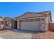 Home exterior featuring a two-car garage with stone accents, brick driveway, and desert landscaping at 5401 W Las Palmaritas Dr, Glendale, AZ 85302