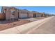 Street view of several single-story homes featuring desert landscaping at 5401 W Las Palmaritas Dr, Glendale, AZ 85302
