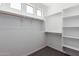 This walk-in closet offers plenty of storage with shelves and wood rods at 5401 W Las Palmaritas Dr, Glendale, AZ 85302