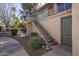 View of the exterior stairway leading to the second floor with desert landscaping at 5626 S Doubloon Ct # E, Tempe, AZ 85283