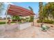 Outdoor living with travertine, shade structure, built-in grill, and egg chairs creates an ideal space for relaxing or entertaining at 5650 E Presidio Rd, Scottsdale, AZ 85254