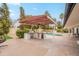 Spacious backyard with a pool, patio, a built-in BBQ, and lush landscaping at 5650 E Presidio Rd, Scottsdale, AZ 85254