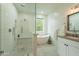 Bright and modern bathroom with a soaking tub and glass enclosed walk-in shower at 5650 E Presidio Rd, Scottsdale, AZ 85254