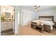 Bedroom featuring wood floors with an attached bathroom and ceiling fan at 5650 E Presidio Rd, Scottsdale, AZ 85254