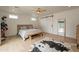 Bedroom with wood floors, ensuite bath, bench at foot of bed, and modern sliding door at 5650 E Presidio Rd, Scottsdale, AZ 85254