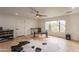 Spacious bedroom with light wood floors, large windows, and modern ceiling fan at 5650 E Presidio Rd, Scottsdale, AZ 85254