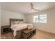 Cozy bedroom with a queen bed, wood flooring, and a modern ceiling fan at 5650 E Presidio Rd, Scottsdale, AZ 85254