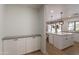 The kitchen has bright white cabinets, countertops, and stainless steel appliances. A large island is perfect for gatherings at 5650 E Presidio Rd, Scottsdale, AZ 85254