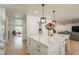 This bright kitchen is open to other living spaces, and has a large kitchen island with stone countertops at 5650 E Presidio Rd, Scottsdale, AZ 85254