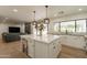 Open-concept kitchen with a large island, modern lighting, and stainless steel appliances is great for entertaining at 5650 E Presidio Rd, Scottsdale, AZ 85254