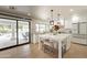 Bright kitchen boasts a large island, stainless steel appliances, and an open layout leading to outdoor pool area at 5650 E Presidio Rd, Scottsdale, AZ 85254