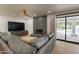 Living room offers comfortable seating, a modern fireplace, and seamless access to the outdoor pool at 5650 E Presidio Rd, Scottsdale, AZ 85254