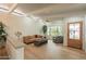 Bright and airy living room with hardwood floors, exposed beams and a decorative ceiling fan at 5650 E Presidio Rd, Scottsdale, AZ 85254