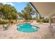 Freeform pool with lounge chairs and travertine tile decking offers an inviting backyard retreat at 5650 E Presidio Rd, Scottsdale, AZ 85254