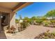 Covered back patio with brick pavers, lush greenery and a green lawn at 6887 S Teresa Dr, Chandler, AZ 85249