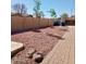 Expansive backyard with rock landscaping and brick-paved path, enclosed by a private block wall at 6887 S Teresa Dr, Chandler, AZ 85249