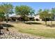 Expansive backyard featuring lush grass, mature trees, and a secure fence at 6887 S Teresa Dr, Chandler, AZ 85249