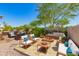 Inviting backyard with lush landscaping, outdoor kitchen and living area, patio, and BBQ at 6887 S Teresa Dr, Chandler, AZ 85249