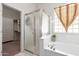 Bathroom featuring bathtub and separate shower stall with glass block window for lots of light at 6887 S Teresa Dr, Chandler, AZ 85249
