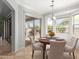 Bright breakfast nook with backyard views, travertine floors, pendant lighting, and neutral color palette at 6887 S Teresa Dr, Chandler, AZ 85249