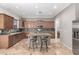 Well-equipped kitchen with an island, granite countertops, and travertine flooring at 6887 S Teresa Dr, Chandler, AZ 85249