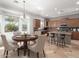 Open kitchen with a center island, stainless steel appliances, eat-in dining area, and bright natural light at 6887 S Teresa Dr, Chandler, AZ 85249