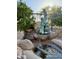 Charming water feature with a statue of two , surrounded by rocks and foliage creating a serene outdoor space at 6887 S Teresa Dr, Chandler, AZ 85249