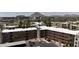 Scenic aerial view of a residential community surrounded by lush landscaping with a mountain in the background at 7625 E Camelback Rd # A110, Scottsdale, AZ 85251