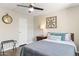 Well-lit bedroom with a ceiling fan, decorative wall art, and luggage rack next to the closet at 7625 E Camelback Rd # A110, Scottsdale, AZ 85251