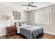 Cozy bedroom with ceiling fan, lamp on nightstand, and decorative wall art above the bed at 7625 E Camelback Rd # A110, Scottsdale, AZ 85251