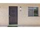 The front door to unit 110A features a decorative security door and is next to a window at 7625 E Camelback Rd # A110, Scottsdale, AZ 85251