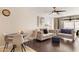 Inviting living room featuring hardwood floors, a ceiling fan, and stylish neutral-toned furniture at 7625 E Camelback Rd # A110, Scottsdale, AZ 85251