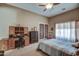 Bright bedroom features a ceiling fan, office desk, and patio access at 907 W Restin Rd, Phoenix, AZ 85086