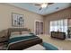 Cozy bedroom with a soft rug, a ceiling fan, and plenty of natural light at 907 W Restin Rd, Phoenix, AZ 85086