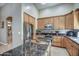 Gourmet kitchen with a center island, stainless steel appliances, and wood cabinetry at 907 W Restin Rd, Phoenix, AZ 85086