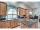 This kitchen offers granite countertops, a stainless steel dishwasher, and light wood cabinetry at 907 W Restin Rd, Phoenix, AZ 85086