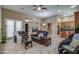 Spacious living room with tile flooring, a fireplace, and modern ceiling fan offers an open and inviting atmosphere at 907 W Restin Rd, Phoenix, AZ 85086