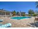 An eye-level of the pool, umbrellas, blue skies and lounge chairs at 907 W Restin Rd, Phoenix, AZ 85086