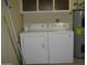 Close-up of the laundry area featuring a washer, a dryer, and storage cabinets at 9221 W Briarwood N Cir, Sun City, AZ 85351