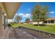 Outdoor patio area with view of well-maintained green space and neighboring homes at 9606 W Shasta Dr, Sun City, AZ 85351