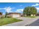 Well-maintained single-story home with an attached garage and verdant lawn at 9606 W Shasta Dr, Sun City, AZ 85351